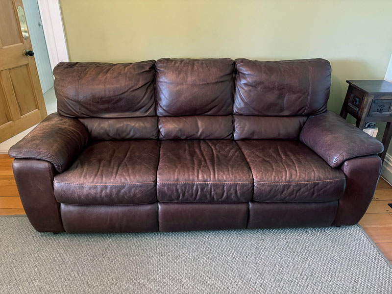 faded,worn leather couch faded,worn leather couch