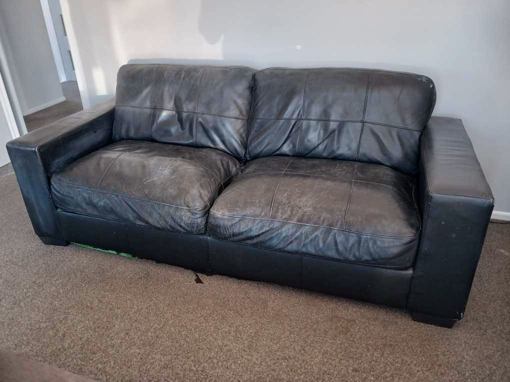 faded worn out leather couch
